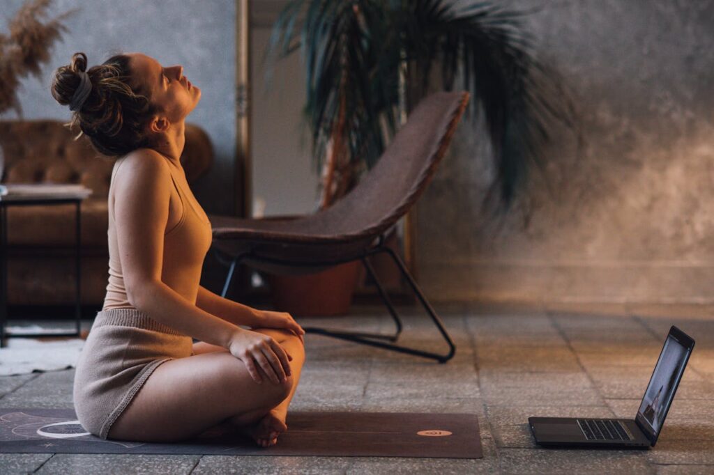 pexels-photo-6246204 Photo of a Woman Stretching Her Neck Near Her Laptop
