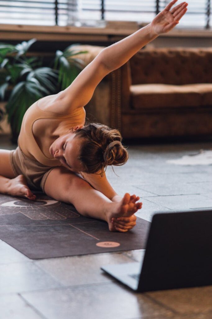 pexels-photo-6246249 Woman in a Beige Top Stretching Near a Laptop